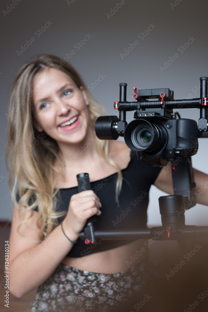 Professional woman videographer with gimball video slr Professional woman videographer with gimball video slr