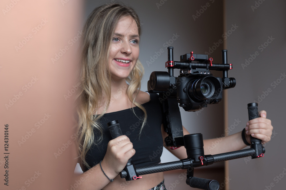 Professional woman videographer with gimball video slr Professional woman videographer with gimball video slr