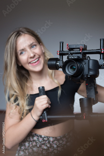 Professional woman videographer with gimball video slr