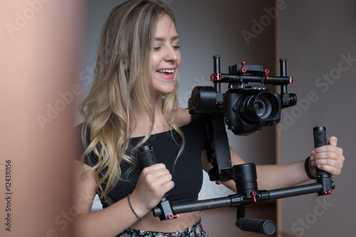 woman videographer with gimball video slr © Myvisuals