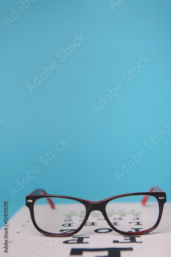 glasses lying on snellen test chart