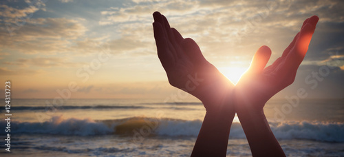 silhouette of female hands during sunset.