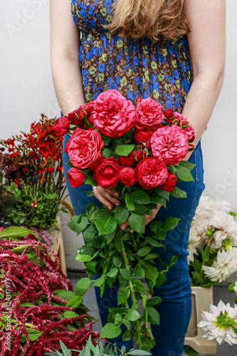 Woman holding bouquet of red roses