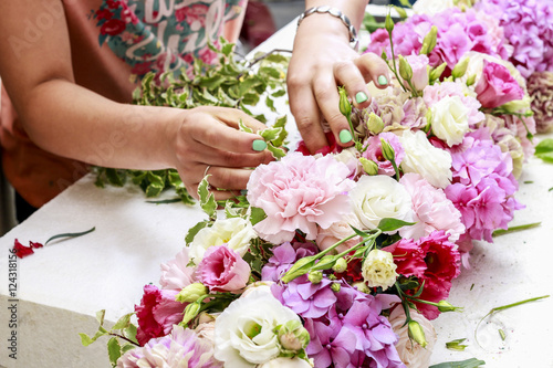 Woman making floral arrangement with carnation  eustoma and hort