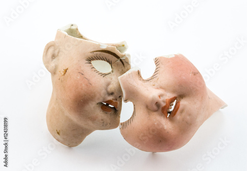 Broken doll parts on white background - Abstract conceptual image