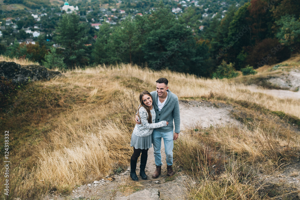 Stylish and fashionable young beautiful happy couple posing. Boho style.