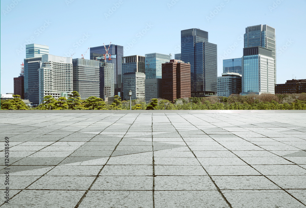 Empty marble floor with cityscape and skyline in clear blue sky
