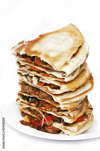 Pile of quesadillas with chicken and vegetables on the isolated on white