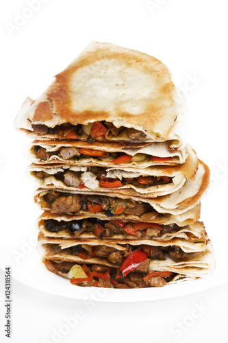 Pile of quesadillas with chicken and vegetables on the isolated on white