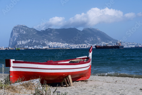 Beach with a boat, and in the background the Rock of Gibraltar.