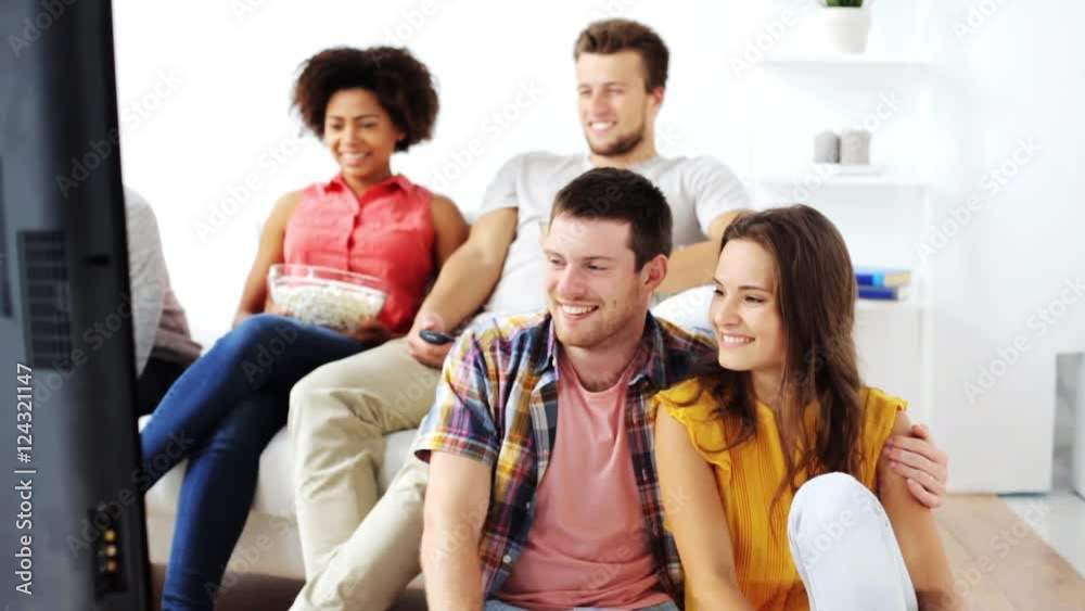 happy friends with popcorn watching tv at home happy friends with popcorn watching tv at home