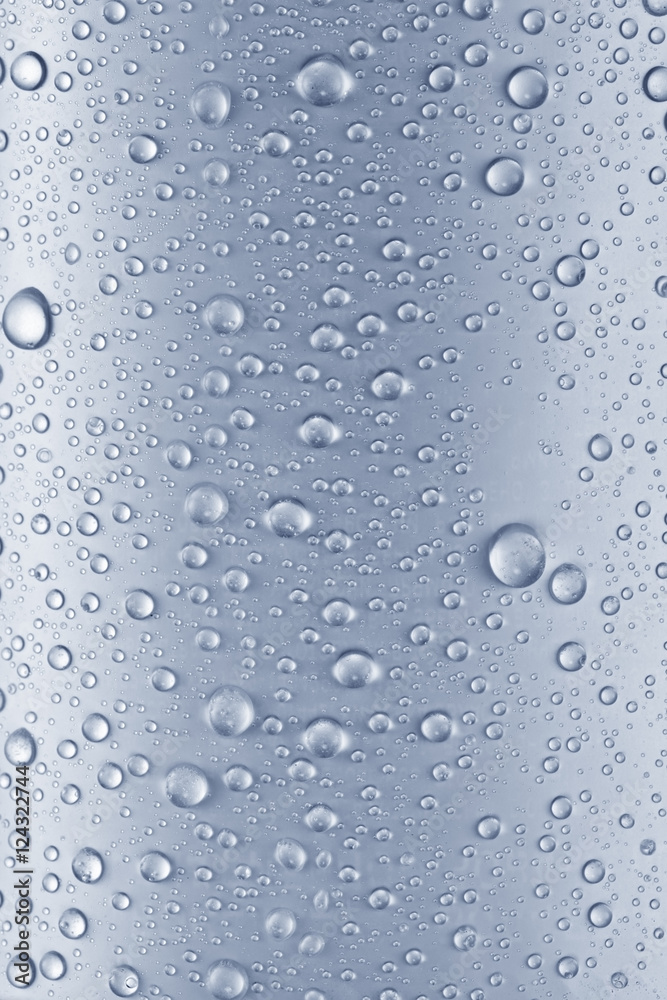 Water drops over blue glass background.