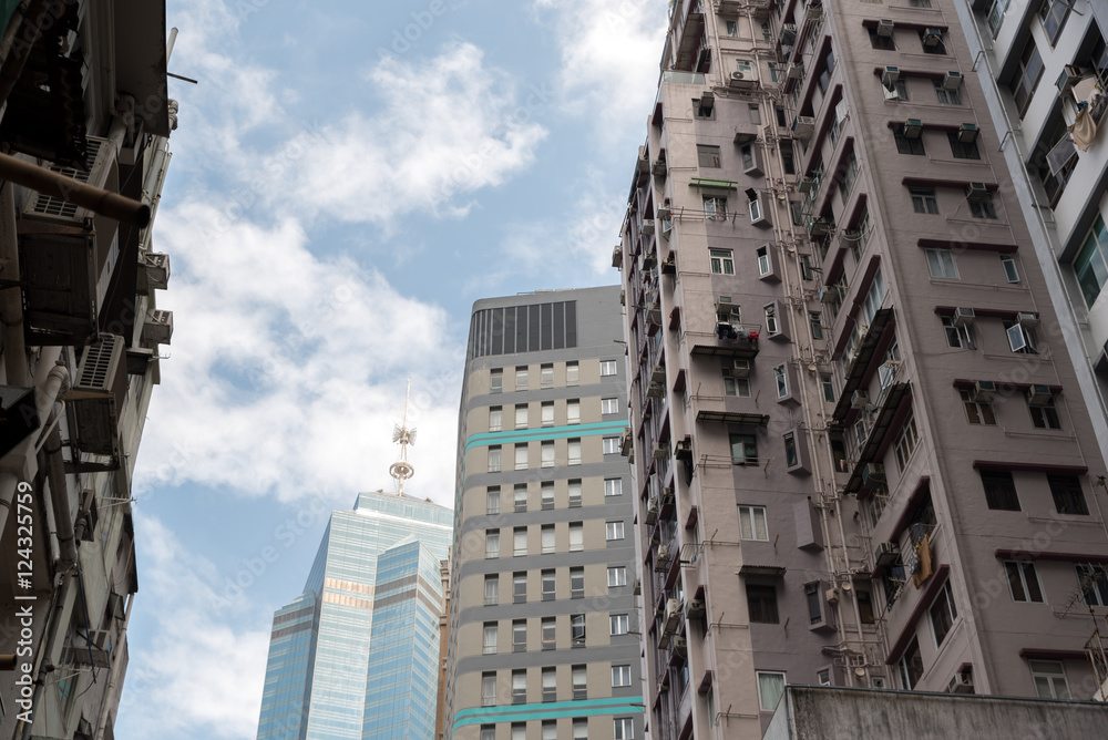 Modern business office skyscrapers, looking up at high-rise buildings in commercial district with blue sky Modern business office skyscrapers, looking up at high-rise buildings in commercial district with blue sky