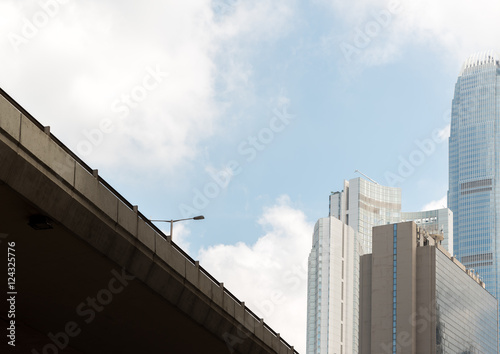 Highway bridge with street light and business skyscrappers with blue sky