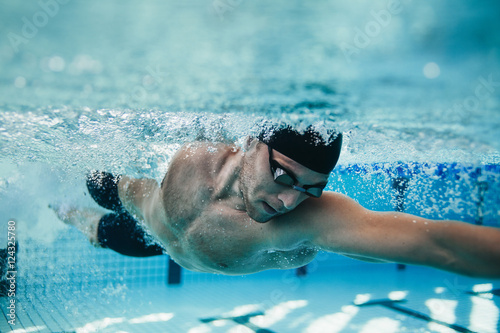 Fototapeta Fit swimmer training in the pool