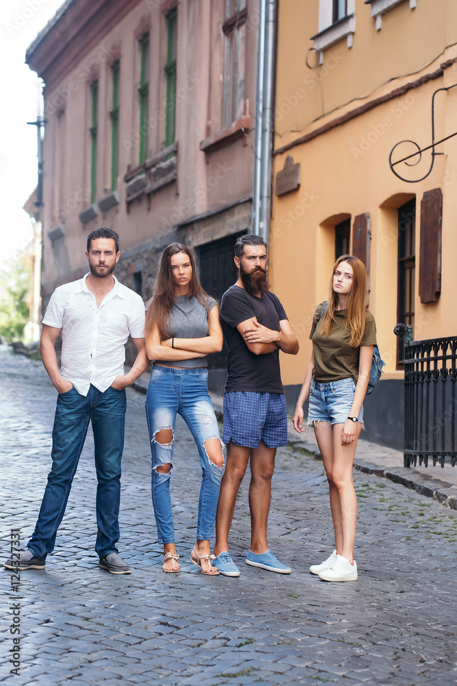 Fototapeta premium Four friends standing on street