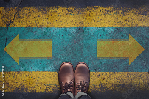 Top view, Male with Leather Shoes, Arrow Sign for Left 0r Right on Grunge Dirty Concrete Floor, Making Decision at the Crossroad