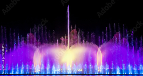 Musical fountain with colorful illuminations at night. 