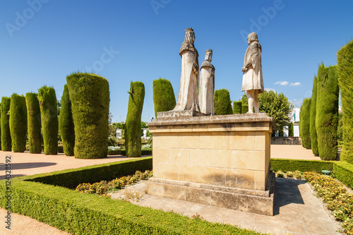Statue of Christopher Columbus standing in front of King Ferdinand and Queen Isabella in the gardens of Alcazar de los Reyes Cristianos, Cordoba, Andalusia province, Spain.