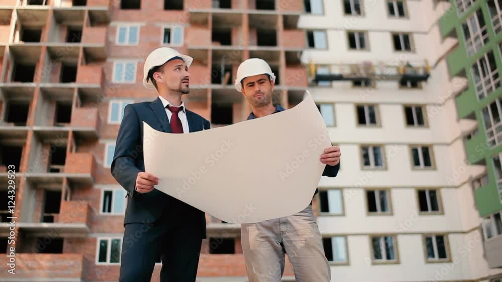 Two foreman looking building plan