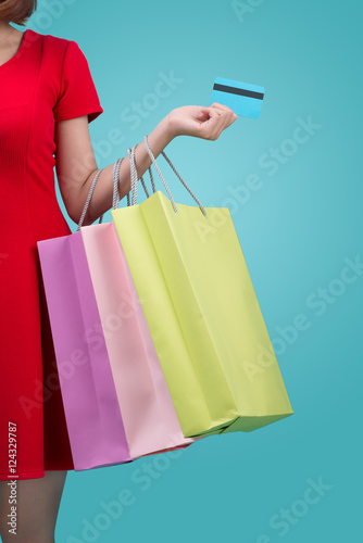 Santa asian woman holding shopping bags and credit card against