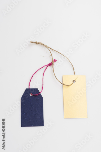 Blue and yellow tag with thread
