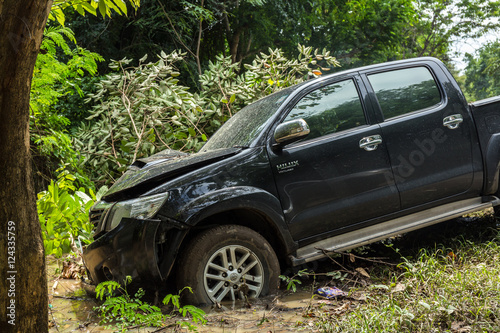 Accident car crash on an suburban street against a tree.