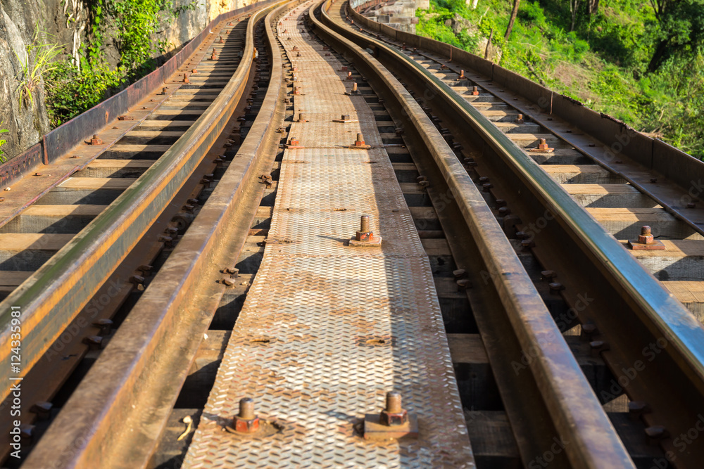 Fototapeta premium Railroad track curve around a bend in thailand