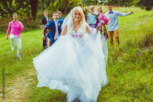 Groom and friends try to catch the running bride