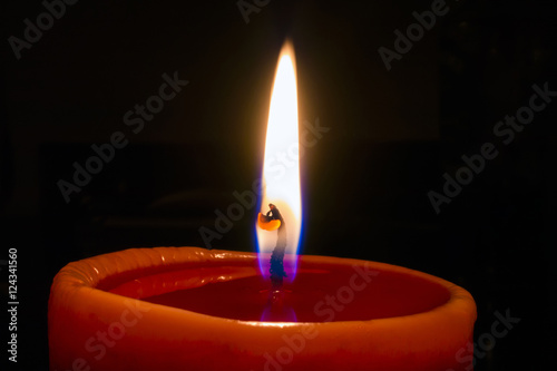 flame of red candle on black background