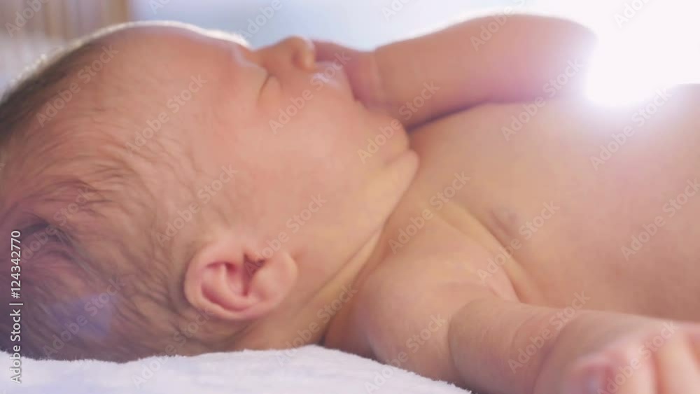 Mom stroking and kissing newborn baby.
Mom stroking and kissing newborn baby.