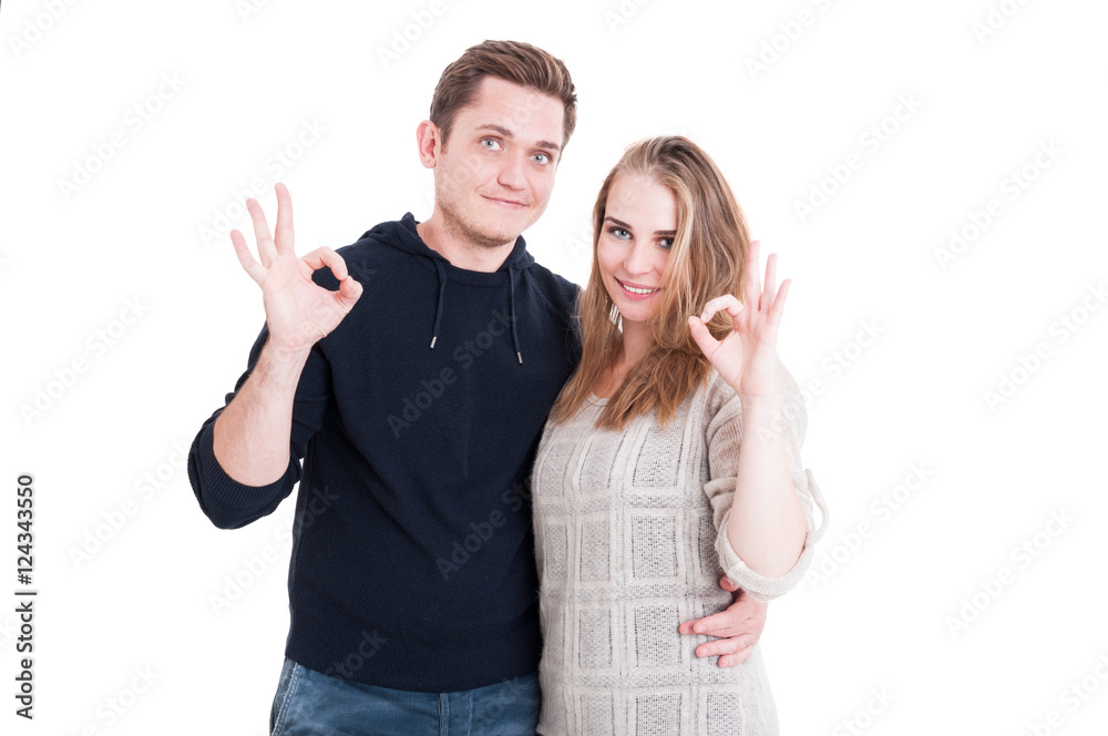 Attractive couple posing and showing ok gesture Attractive couple posing and showing ok gesture