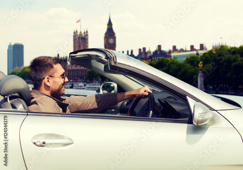 Photography happy man near cabriolet car over london city