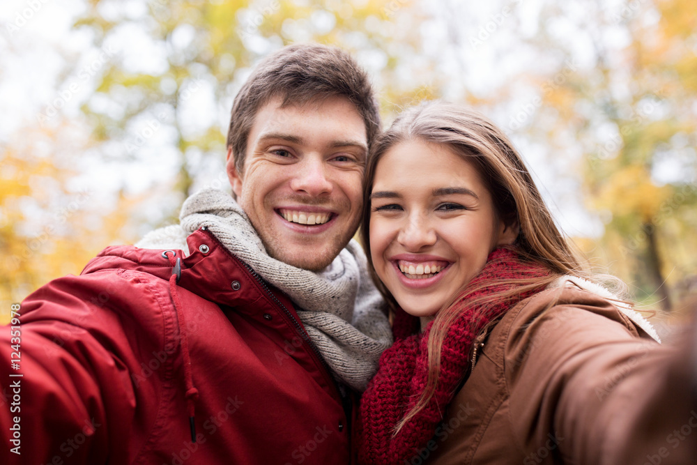 happy young couple taking selfie in autumn park happy young couple taking selfie in autumn park