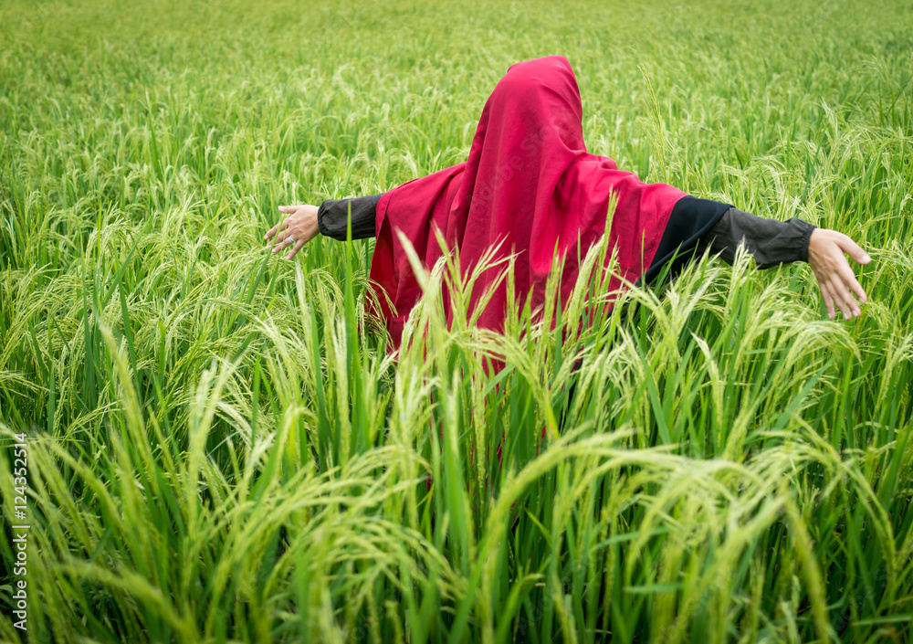 Beautiful happy Muslim woman in green field Beautiful happy Muslim woman in green field