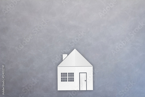 house paper cut shape on grey leather background