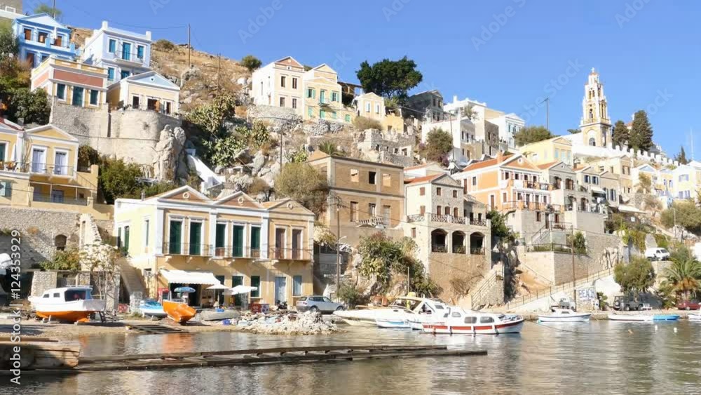 Symi island - Colorful houses and small boat, pan right footage at the heart of the village Symi island - Colorful houses and small boat, pan right footage at the heart of the village