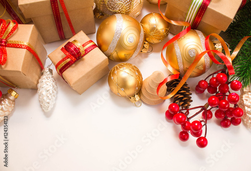 Christmas or New Year background: fur-tree, branches, gifts, colored glass balls, decoration and cones on a white background