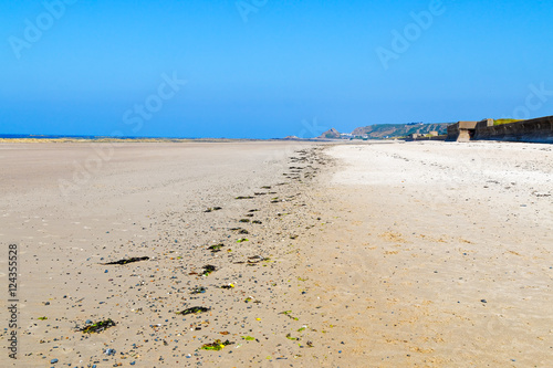 Obraz na płótnie A line of debris left by at low tide on a Jersey beach.