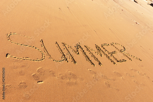 Summer word written in the sandy beach © kelifamily