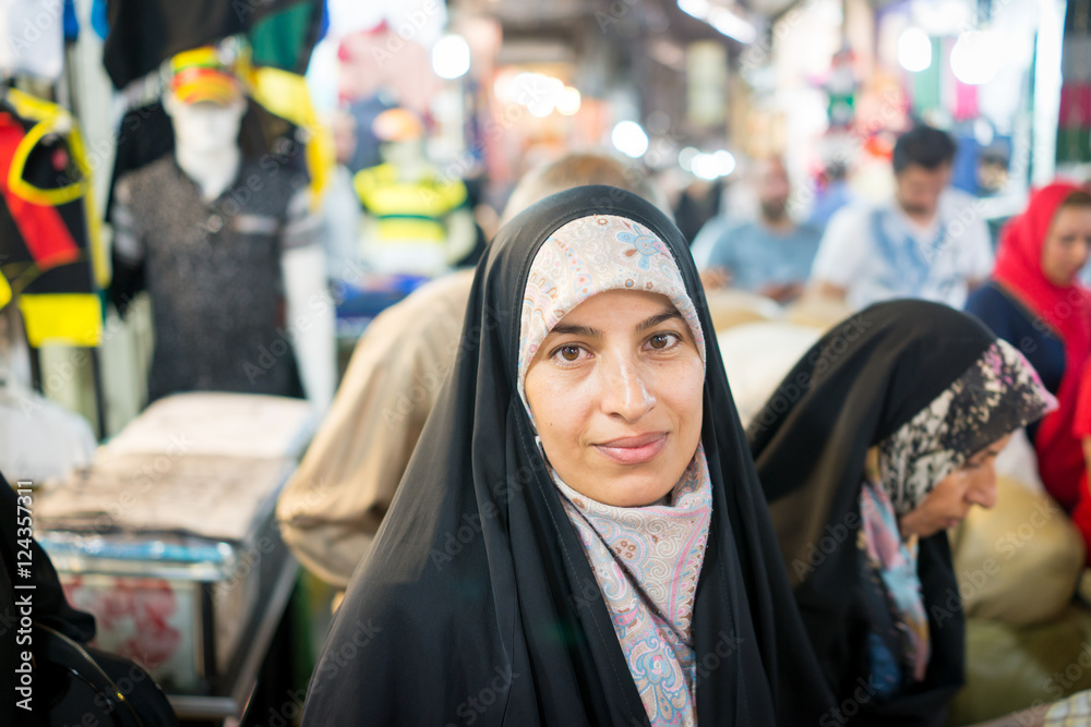 Naklejka premium Beautiful Muslim woman spending time on traditional Iranian baza