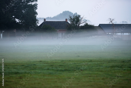 Old dutch farm in morning mist. Geesteren. Gelderland. The Nethe photo