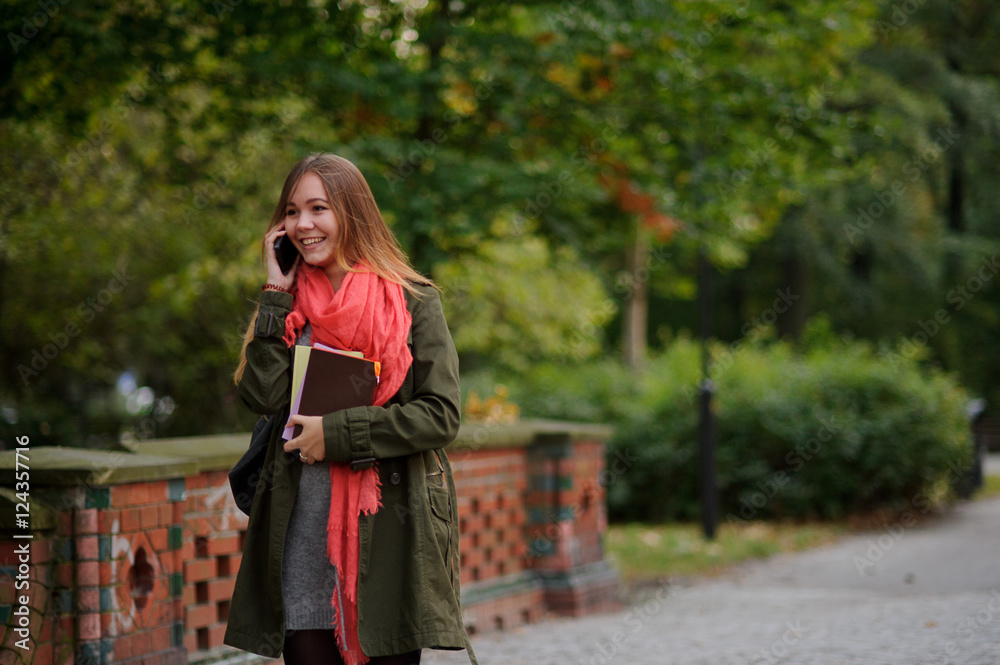 Young attractive woman walks in the autumn park.