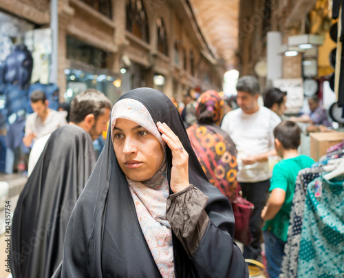 Beautiful Muslim woman spending time on traditional Iranian baza