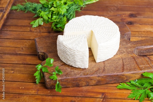 Soft salty cheese on a wooden table