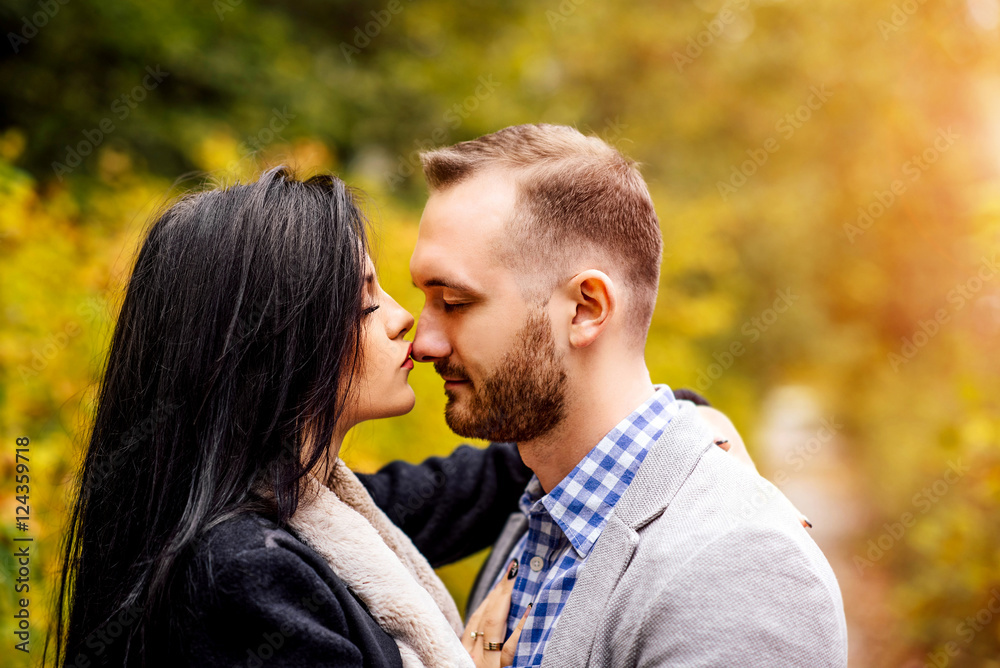 Pretty couple walking outdoor in the park Pretty couple walking outdoor in the park