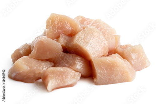 Pile of dices skinned deboned raw chicken breast isolated on white. photo