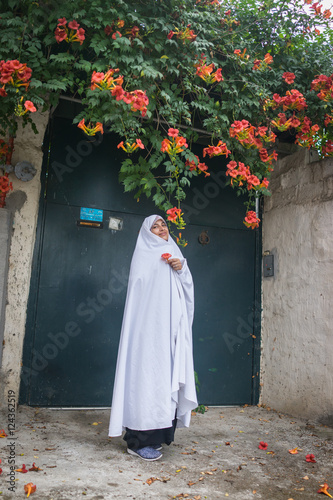 Bild auf Leinwand Beautiful Muslim woman in front of her house