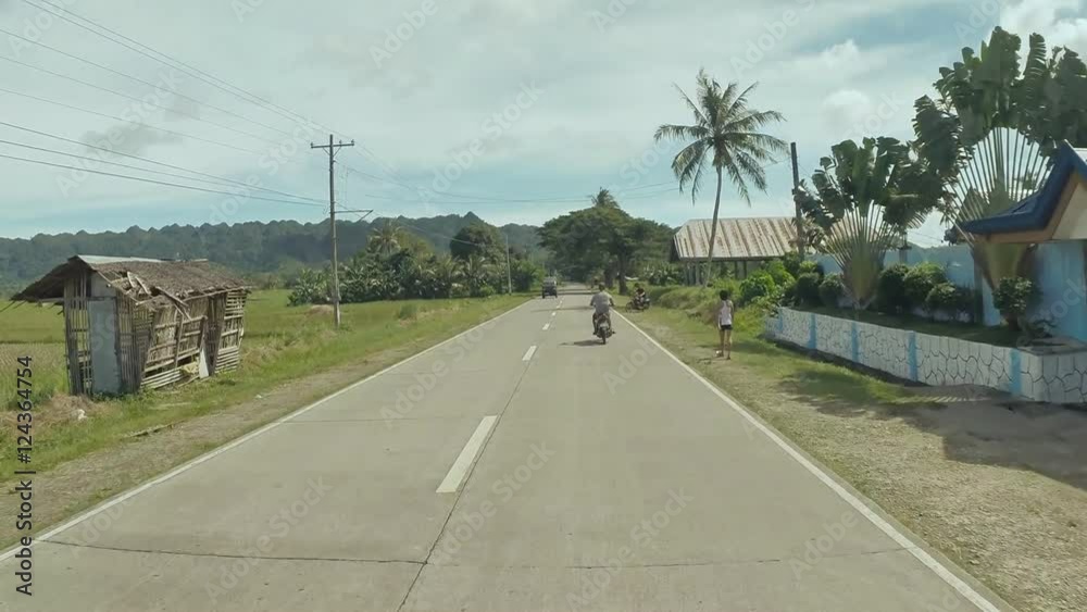 Village Road. Motion on motorbike. Philippines. Bohol island. Driving forward..