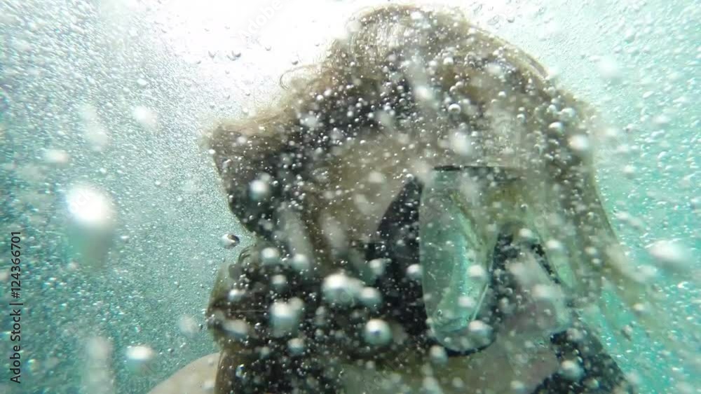 Snorkel in Caribbean, a male snorkeler backflips off a boat and launches into the Caribbean, the camera goes underwater with him, Belize tourism.